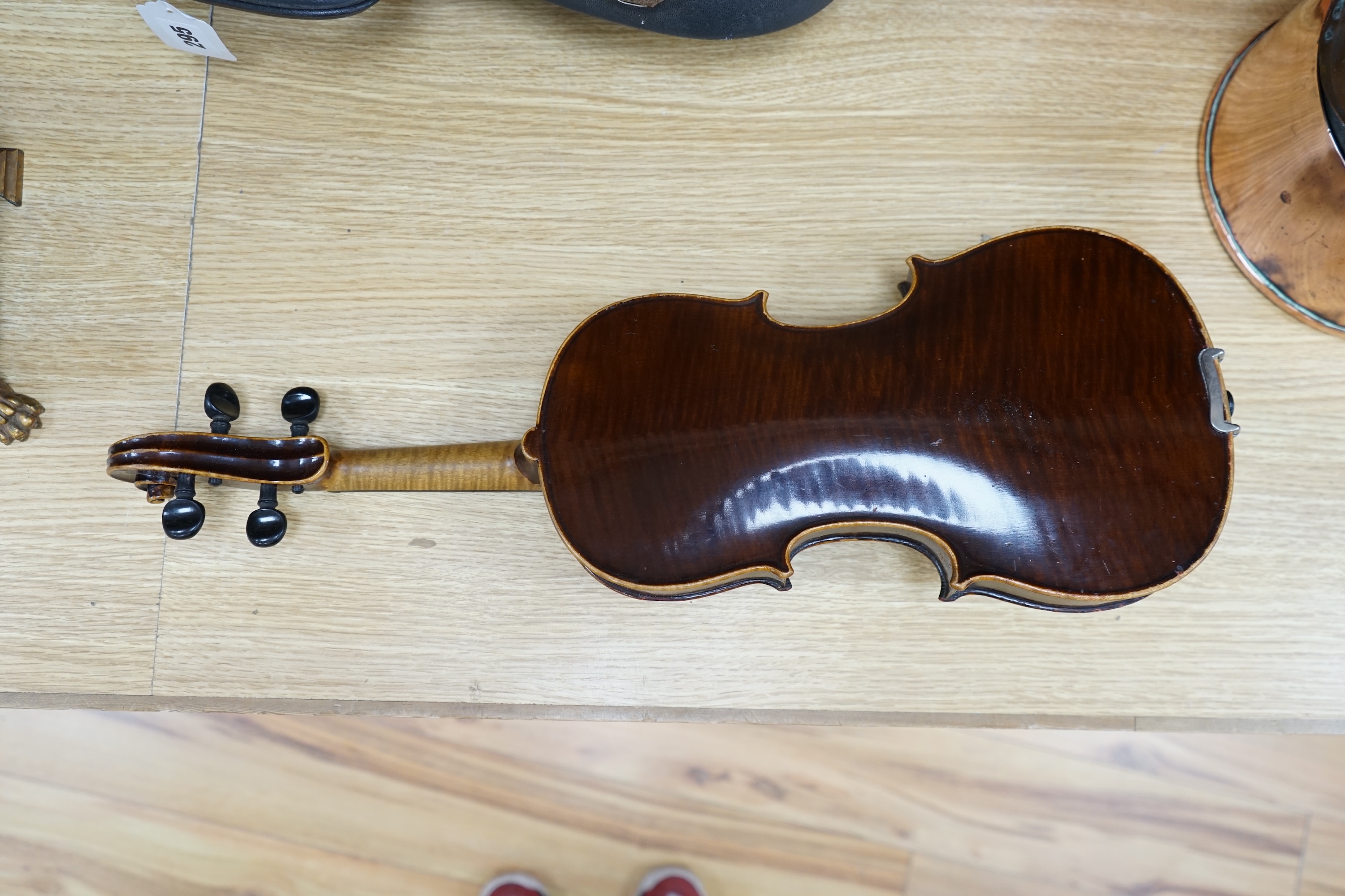 An early to mid 20th century violin, interior label reads ‘Copy of Antonius Straduarius made in Germany’, cased with bow, back measures 33.5cm. Condition - fair to good